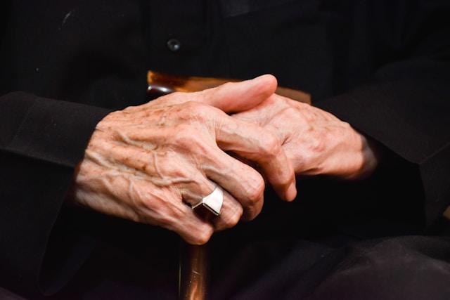 Gentle elderly hands, representing the tender memory of a parent lost