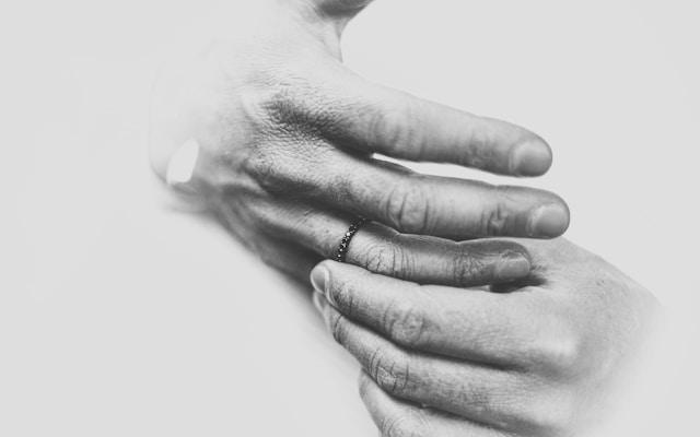 Hands resting on a chest, representing the physical weight and pain that grief places on the body