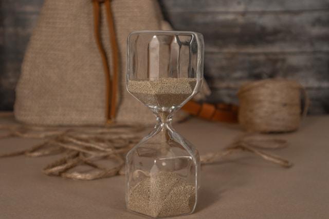 An hourglass in soft light, representing the passage of time in grief